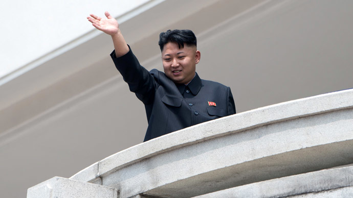 North Korean leader Kim Jong-Un waves to the crowd during a military parade at Kim Il-Sung square marking the 60th anniversary of the Korean war armistice in Pyongyang on July 27, 2013. (AFP Photo/Ed Jones)