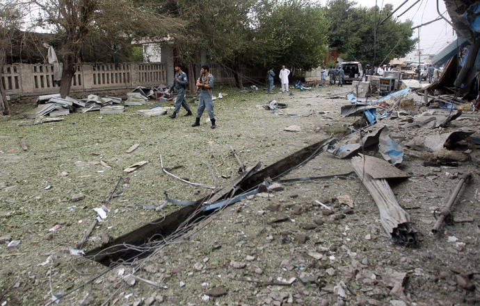 Afghan policemen walk at the site of a suicide attack in Jalalabad province August 3, 2013. (Reuters/Parwiz)