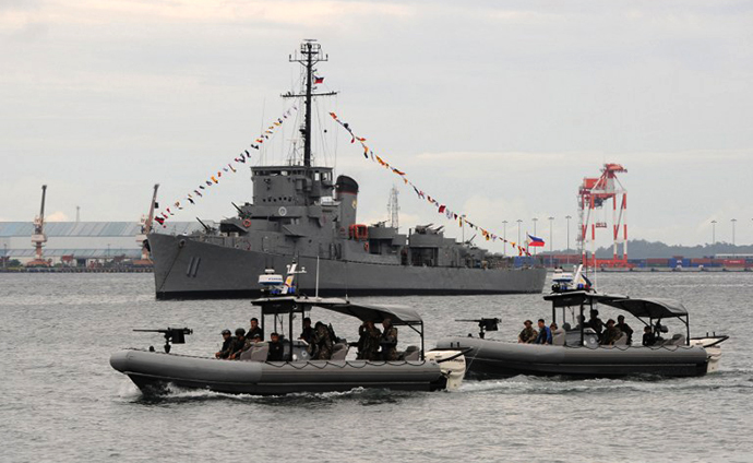 A Philippine Navy special operations group (NAVSOG) on board speed boats patrols off Subic Bay, facing the South China Sea, on August 6, 2013, as they wait for the arrival of the BRP Ramon Alcaraz, a high-endurance Hamilton-class cutter that had been decomissioned by the US Coast Guard and acquired by Manila. (AFP Photo / Ted Aljibe)