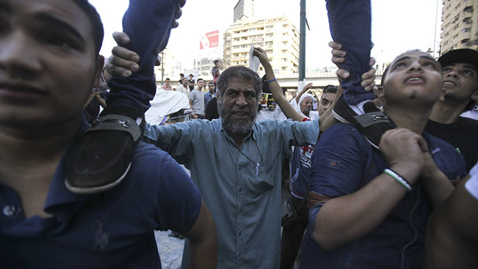 Supporters of the Muslim Brotherhood and ousted Egyptian President Mohamed Mursi shout slogans against the military and interior ministry during a protest in front of Al Istkama mosque at Giza Square, south of Cairo, August 18, 2013. (Reuters / Amr Dalsh)