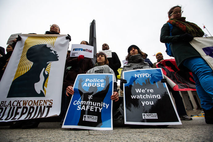 Demonstrators hold signs protesting the New York Police Department's "stop and frisk" crime-fighting tactic outside of Manhattan Federal Court in New York, March 18, 2013. (Reuters / Lucas Jackson)