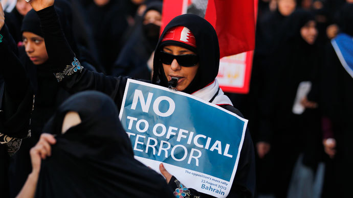 Anti-government protesters holding Bahraini flags and signs saying "No To Official Terror" march during a rally organized by Bahrain's main opposition party Al Wefaq on Budaiya highway west of Manama August 23, 3013. (Reuters / Hamad I Mohammed)