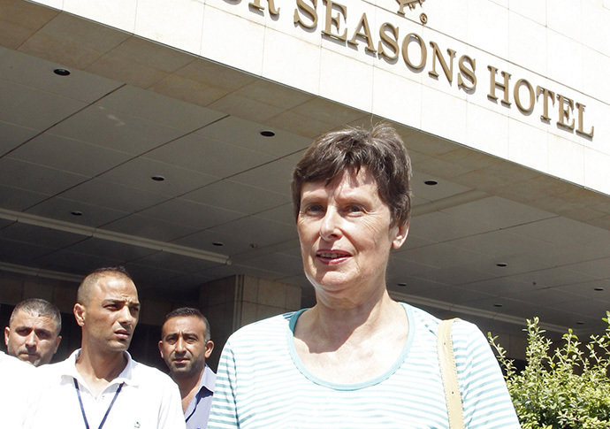 United Nations (U.N.) High Representative for Disarmament Affairs Angela Kane stands outside a hotel to watch a convoy of U.N. inspectors heading to the scene of an alleged chemical weapons strike in the rebel-held area known as Eastern Ghouta, on the outskirts of the capital Damascus August 26, 2013. (Reuters / Khaled Al Hariri)