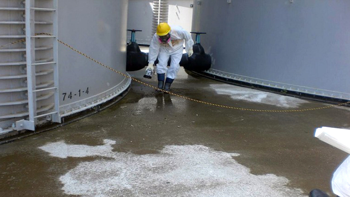 A TEPCO worker checking radiation levelS around a contaminated water tank at TEPCO's Fukushima Dai-ichi nuclear power plant at Okuma town in Fukushima prefecture. (AFP Photo / TEPCO)