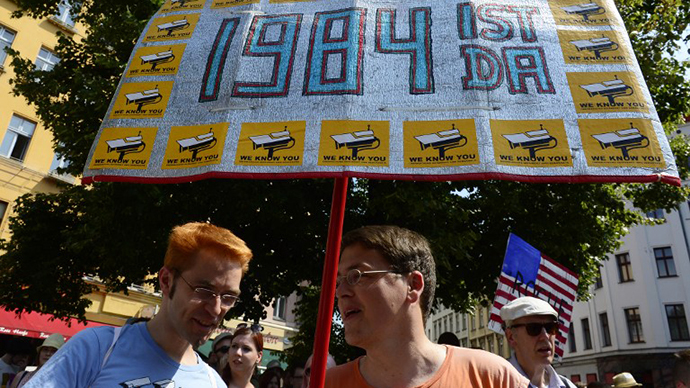 Demonstrators hold up a placard which reads "1984 is here" as they take part in a protest against the US National Security Agency (NSA) (AFP Photo / John Macdougall)