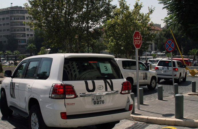 A convoy of United Nations (UN) vehicles leave a hotel in Damascus (AFP Photo)