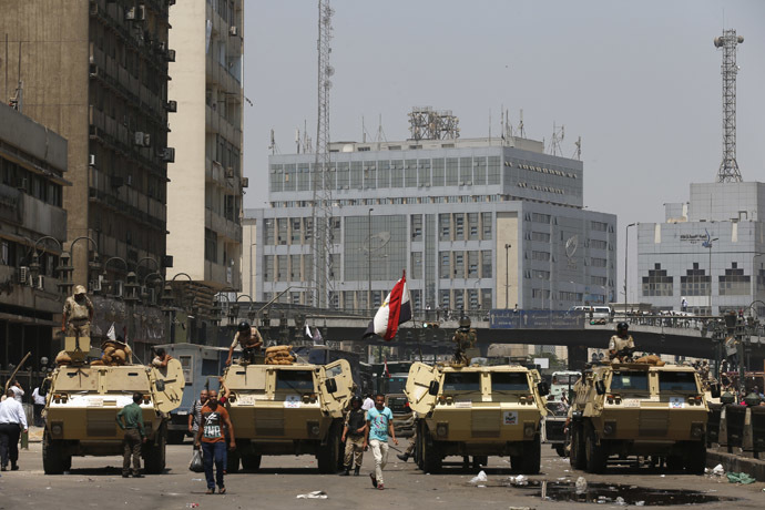 Soldiers stand guard on an armoured personnel carrier positioned outside Ramses Square, near al-Fath mosque in Cairo August 17, 2013. (Reuters/Youssef Boudlai)