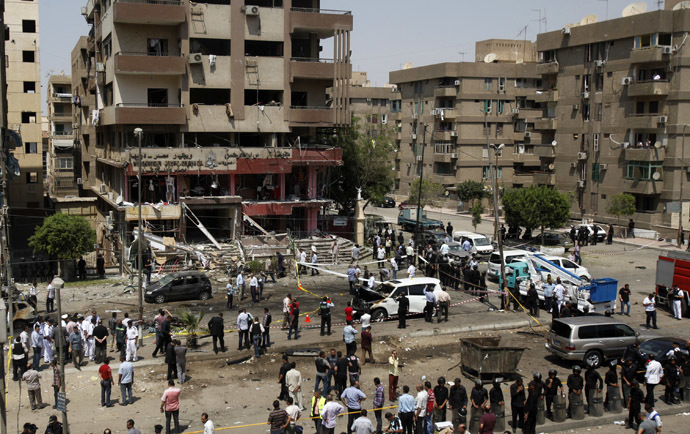 A general view shows policemen investigating next to burnt cars at the site of a bomb attack and assassination attempt near the house of Egypt's Interior Minister Mohamed Ibrahim in the Nasr City district of Cairo September 5, 2013. (Reuters/Amr Abdallah Dalsh)