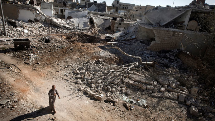 A man walks through a destroyed residential area of the Syrian city of Saraqib, southwest of Aleppo, on September 9, 2013.(AFP Photo / Giovanni Diffidenti)