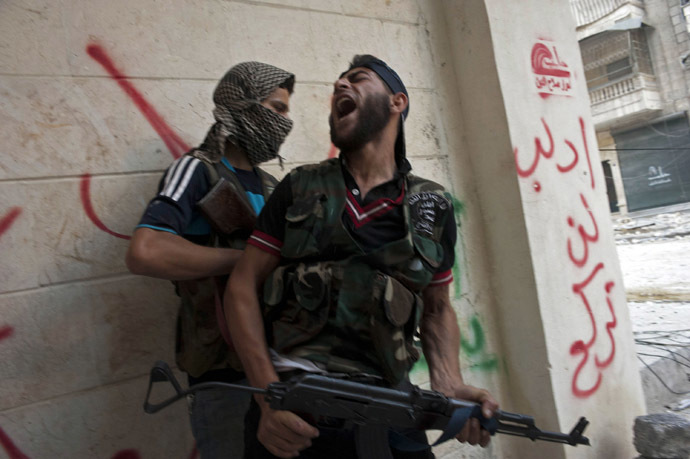 Free Syrian Army fighters take cover as they exchange fire with regime forces in the Salaheddin neighbourhood of Syria's northern city of Aleppo (AFP Photo/James Lawler Duggan)