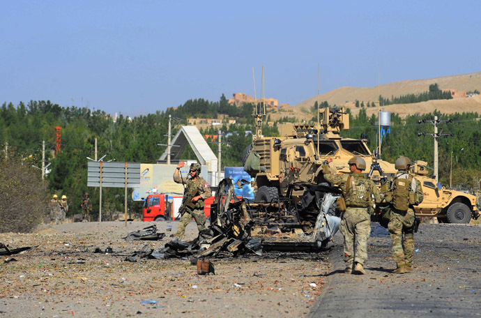 US military forces walk at the wreckage of a car bomb near the US consulate after an attack in Herat on September 13, 2013. (AFP Photo/Aref Karimi)