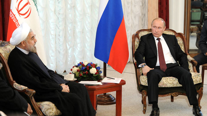 Russia's President Vladimir Putin speaks with his Iranian counterpart Hassan Rowhani as they meet on the sidelines of a summit of the Shanghai Cooperation Organization (SCO) in the Kyrgyzstan's capital Bishkek, on September 13, 2013.(AFP Photo / Mikhail Klimentyev)