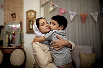 Nasrin Sotoudeh hugs get son on September 18, 2013, after being freed after three years in prison. (AFP Photo / Behrouz Mehri)