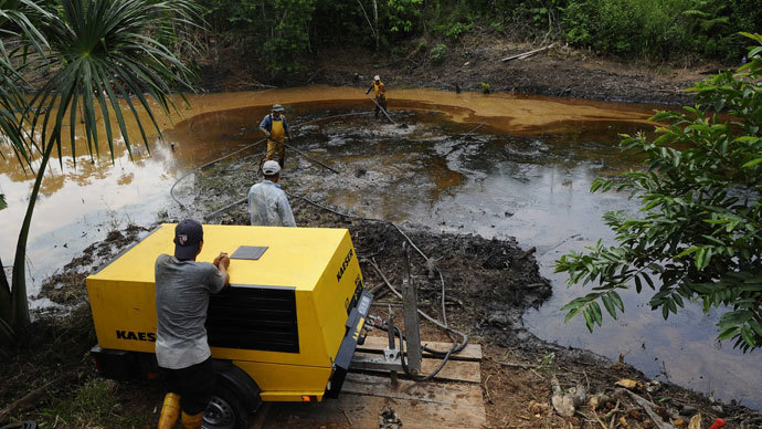 Employees of state-owned Petroecuador work on environmental cleansing operations of a 30-year old oil spillage at the Rumipamba commune, 200 mt from the Auca Sur 1 oil well --operated by US Chevron Texaco in the seventies--, in the province of Orellana, Amazonia, on February 20, 2011.(AFP Photo / Rodrigo BгÑÑdia)