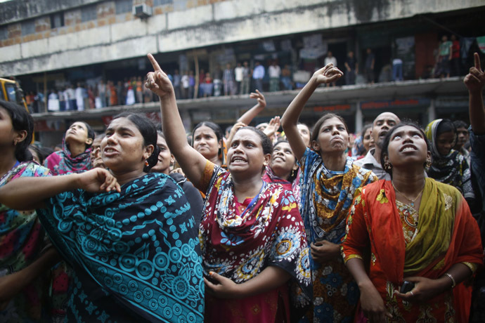 Garment workers shout as they call other workers to join them, in front of Brothers Fashion Limited, during a protest in Dhaka September 23, 2013. (Reuters/Andrew Biraj)