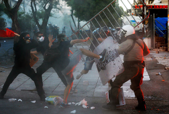 Protesters clash with riot police during clashes between police and angry anti-fascist protesters following the killing of a 35-year-old anti-racism rapper by a man who sympathized with the far-right Golden Dawn group in an Athens suburb September 18, 2013.(Reuters / Yannis Behrakis)