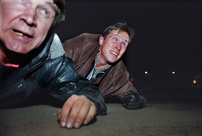 A file picture late on October 3, 1993, shows anti-Yeltsin activists taking cover under gunfire near Ostankino television centre during the parliamentary revolt in Moscow.(AFP Photo / Alexander Nemenov)