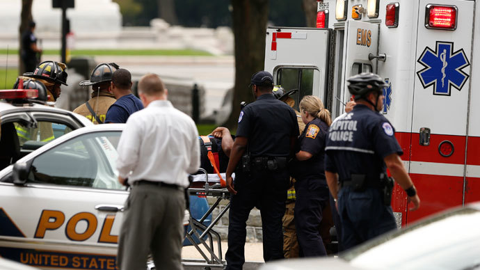 Rescue personnel evacuate a person from a crashed vehicle following a shooting near the U.S. Capitol in Washington, October 3, 2013.(Reuters / Kevin Lamarque)