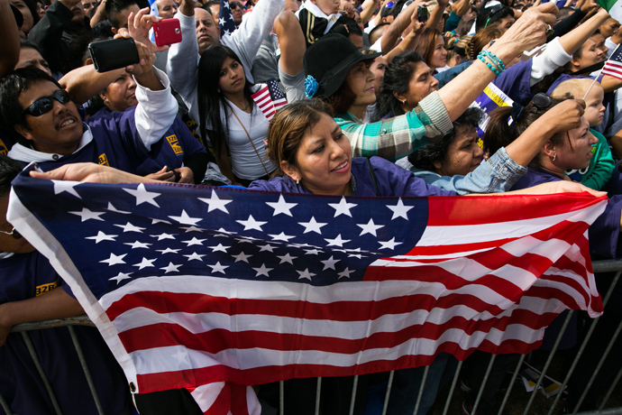 Lorena Ramirez, of Arlington, Virginia, holds up an American flag during a rally in support of immigration reform, in Washington, on October 8, 2013 in Washington, DC (Drew Angerer/ Getty Images / AFP)