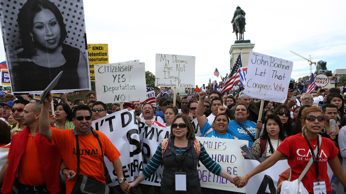 Protesters link hands during a protest rally for immigrants rights on Capitol Hill in Washington October 8, 2013 (Reuters / Gary Cameron)