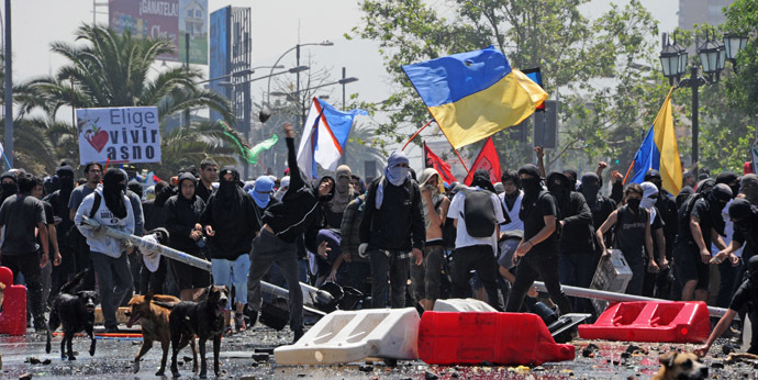 Students clash with riot police during a protest to demand Chilean President Sebastian Pinera's government to improve public education quality, in Santiago, on October 17, 2013. (AFP Photo/Martin Bernetti)