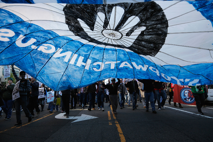 Demonstarators carry a parachute during the "Stop Watching Us: A Rally Against Mass Surveillance" march near the U.S. Capitol in Washington, October 26, 2013. (Reuters / Jonathan Ernst)