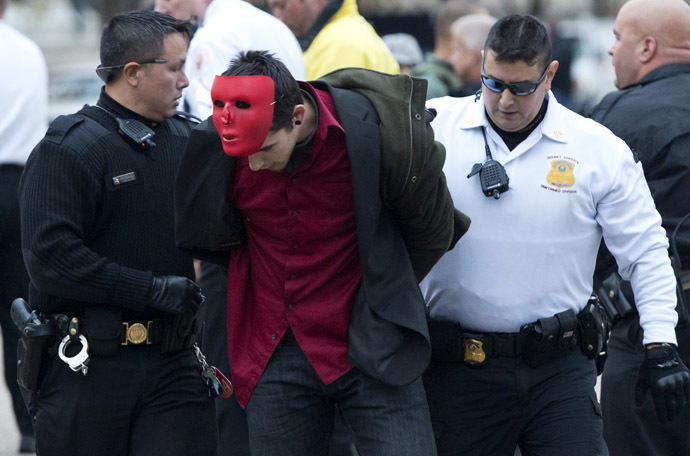 Police arrest a protestor during a march against corrupt governments and corporations organized by supporters of the group Anonymous, in front of the White House in Washington, DC, November 5, 2013, as part of a Million Mask March of similar rallies around the world on Guy Fawkes Day. (AFP Photo/Saul Loeb)