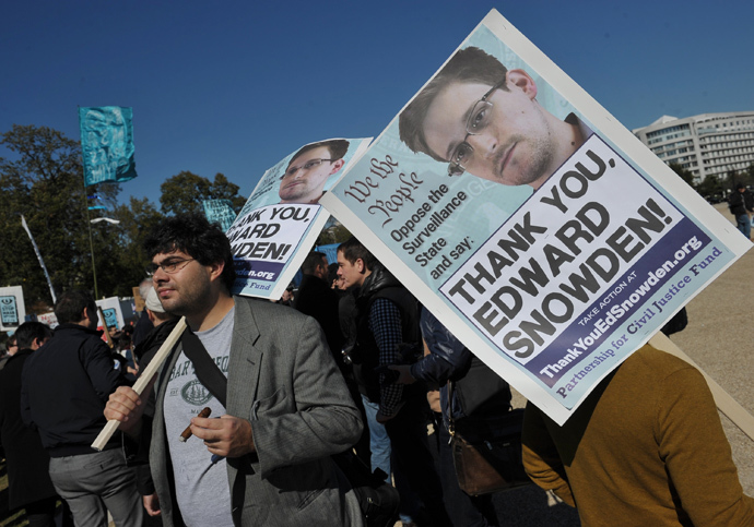 Demonstrators hold placards supporting former US intelligence analyst Edward Snowden during a protest against government surveillance in Washington, DC. (AFP Photo / Mandel Ngan)