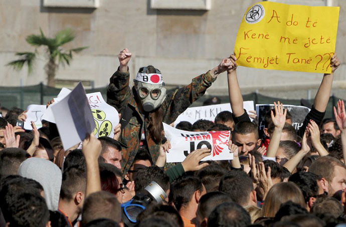 A man wearing a gas mask joins Albanian environmental activists as they take part in a protest in front of the Prime MinisterÃs office in Tirana on November 15, 2013, over the possibility of the Republic of Albania processing and destroying 1.000 tons of chemical weapons from Syria in its military facilities (AFP Photo / Gent Shkullaku)