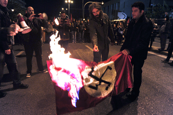 Leftist students burn a Nazi flag in front of the US embassy in Athens, during a march commemorating the 1973 students uprising against the military junta. Tens of thousands marched in Greece on November 17 (AFP Photo / Louisa Gouliamaki)