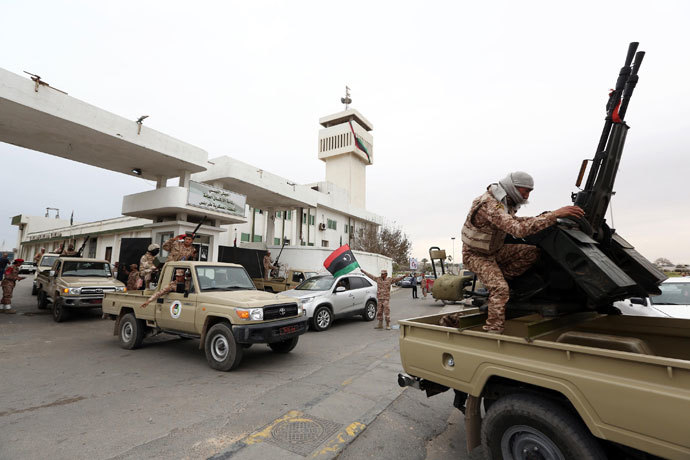 Libyan soldiers with an anti-aircraft machine gun mounted on a vehicle deploy in a Tripoli's neighborhood after militias were ordered to leave the capital following weekend clashes on November 18, 2013.(AFP Photo / Mahmud Turkia)