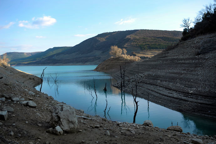 Trees are reflected in the waters of the Yesa reservoir, about 50 km (31 miles) from Pamplona, northeast Spain March 22, 2012. High atmospheric pressure has blocked Atlantic Ocean frontal systems from moving into Europe and Spain has registered its lowest rainfall levels since 1947 in the December-February period, which have affected wheat and barley production levels, according to local media sources quoting the country's Agriculture Ministry.(Reuters / Vincent West)