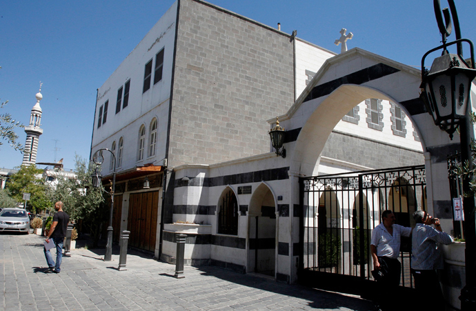 People stand in front of the entrance of the Catholic Patriarchate in the Christian quarter of Damascus (Reuters / Khaled al-Hariri)