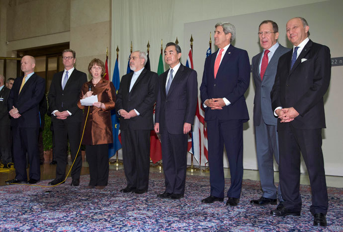 (L-R) British Foreign Secretary William Hague, Germany's Foreign Minister Guido Westerwelle, EU foreign policy chief Catherine Ashton, Iranian Foreign Minister Mohammad Javad Zarif, Chinese Foreign Minister Wang Yi, U.S. Secretary of State John Kerry, Russia's Foreign Minister Sergei Lavrov and French Foreign Minister Laurent Fabius gather at the United Nations Palais in Geneva November 24, 2013.(Reuters / Carolyn Kaster)