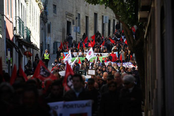 Protestors march as they protest during the vote of the 2014 State Budget in downtown Lisbon on November 26, 2013.(AFP Photo / Pedro Nunes)