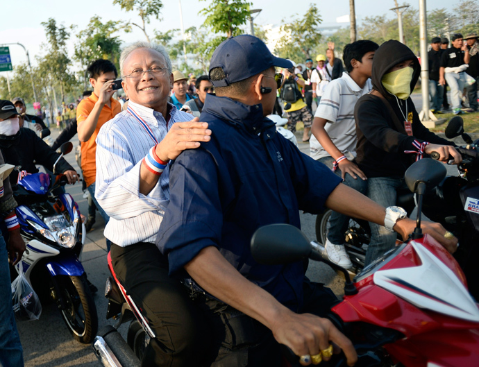 Protest leader Suthep Thaugsuban rides on the back of a motorcycle among anti-government protesters during a rally in Bangkok December 9, 2013. (Reuters / Dylan Martinez)