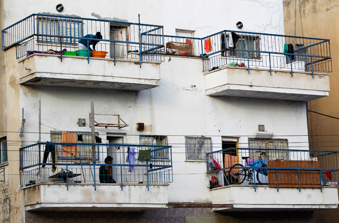 African migrants stand on their balconies at an apartment block in south Tel Aviv (Reuters / Amir Cohen)