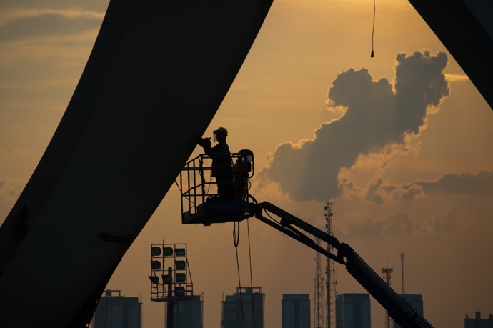 A man working at the Arena da Amazonia stadium. (AFP Photo / Christophe Simon)