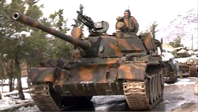 The Syrian army on a mission to force rebels out of the town of Adra. Still from RT video