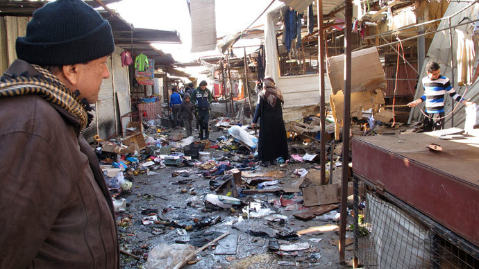 A man looks at the site of bomb attack at a marketplace in Baghdad's Doura District December 25 2013.(Reuters / Ahmed Malik)