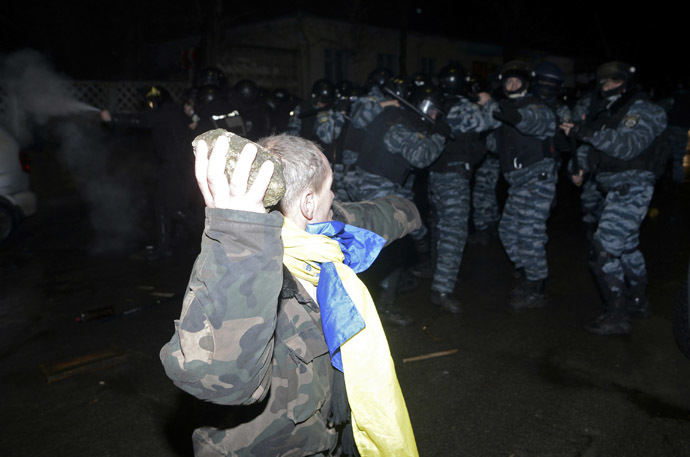 An opposition activist clashes with riot police during a rally near a court in Kiev January 10, 2014. (Reuters/Maks Levin)