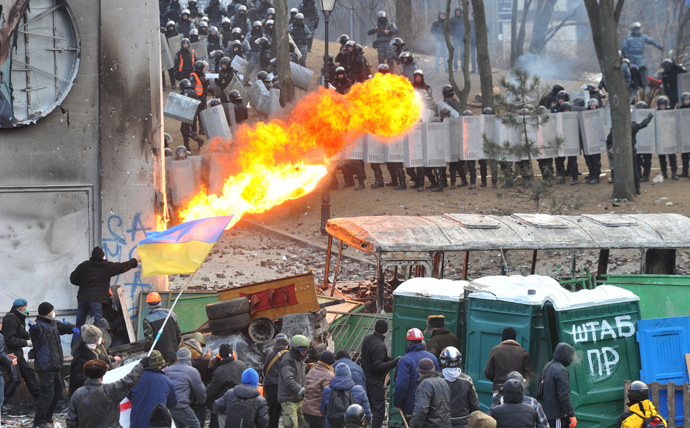 A protester sprays fire in the direction of the riot police during clashes in the centre of Kiev on January 20, 2014. (AFP Photo / Genya Savilov)