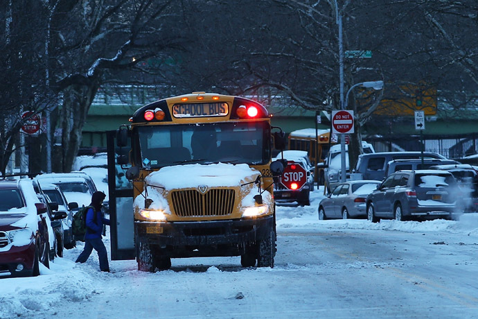 A school bus picks up children in Brooklyn on the morning after a major winter storm blanketed much of New York City in 10 to 12 inches of snow on January 22, 2014 in New York City. (Spencer Platt/Getty Images/AFP)
