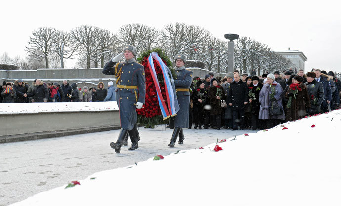 January 27, 2014. Russian President Vladimir Putin, middle ground center, participates in a wreath-laying ceremony at the Motherland memorial at St. Petersburg's Piskaryovskoye Memorial Cemetery.(RIA Novosti / Michael Klimentyev)