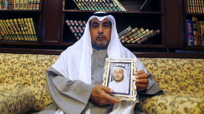 Khalid al-Odah, the father of Fawzi al-Odah, one of two Kuwaiti detainees still being held at Guantanamo Bay , holds his sonâs picture, at his home in the Qurtuba district of Kuwait City (AFP Photo)