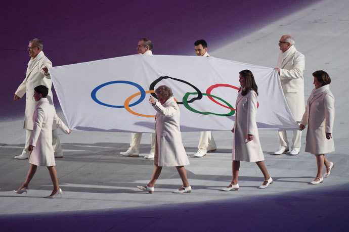The Olympic flag is brought on stage during the Opening Ceremony of the Sochi Winter Olympics at the Fisht Olympic Stadium on February 7, 2014 in Sochi.(AFP Photo / Damien Meyer)