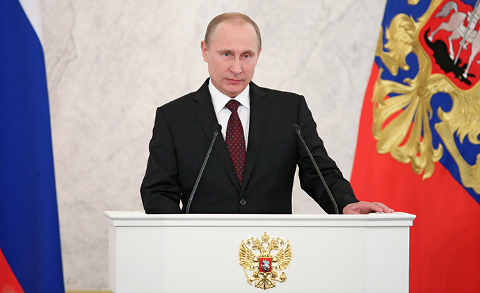December 12, 2013. President Vladimir Putin reads his annual address to the Federal Assembly in the St. George's Hall of the Kremlin. (RIA Novosti / Mihail Metzel)