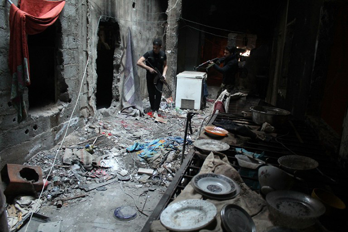 Rebel fighters inspect an alley in the eastern Syrian town of Deir Ezzor on February 14, 2014. (AFP Photo / Ahmad Aboud)