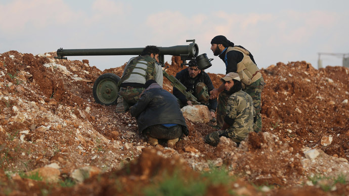 Rebel fighters prepare to fire an anti-tank cannon towards the government forces Al-Samman checkpoint on a road leading to Idlib near the Syrian city of Hama, on February 17, 2014. (AFP Photo / Abu Hadi Al-Hamwi)