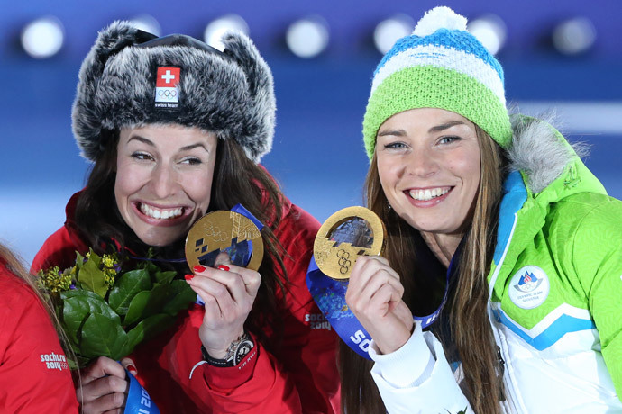 (L-R) Gold medalists Switzerland's Dominique Gisin and Slovenia's Tina Maze pose on the podium during the Women's Alpine Skiing Downhill Medal Ceremony at the Sochi medals plaza during the Sochi Winter Olympics on February 12, 2014. (AFP Photo / Loic Venance)
